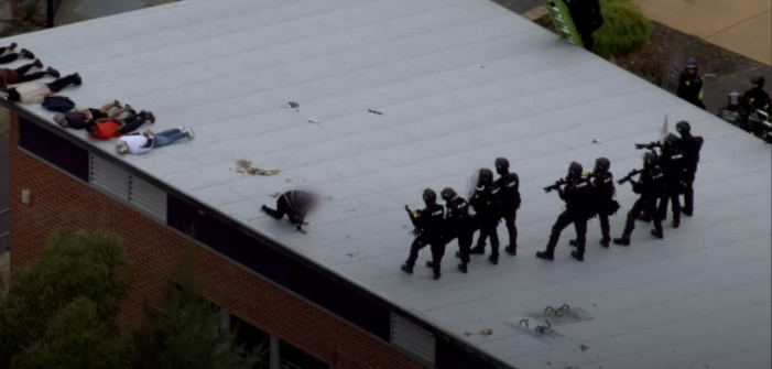 Vision shows armed officers in riot gear bringing an end to the disturbance on the roof of Banksia Hill. (Source: ABC News)