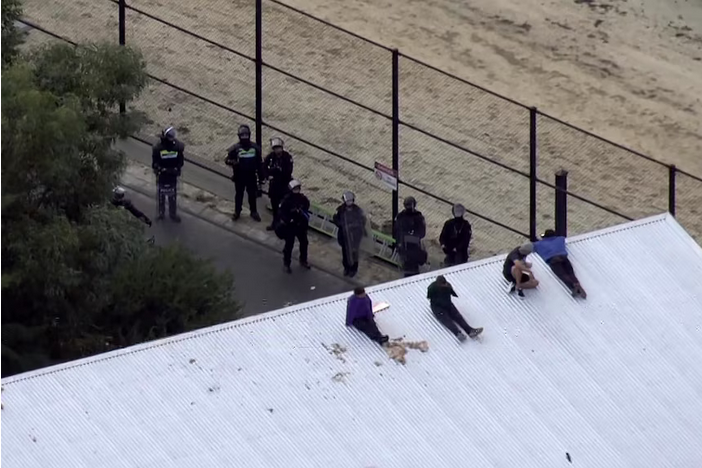 A group of detainees at Banksia Hill Juvenile Detention Centre in Perth on the roof of the building last month.(ABC News)