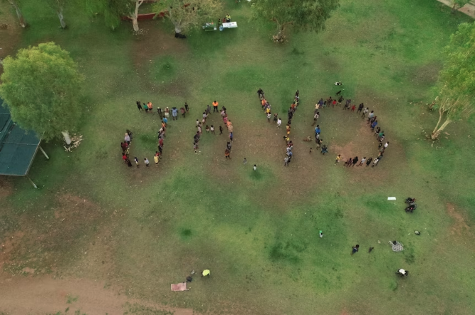 A year after Jeremiah Rivers disappeared, loved ones gathered to write his nickname, "Jayo", in Warmun.(ABC Kimberley: Ted O'Connor)