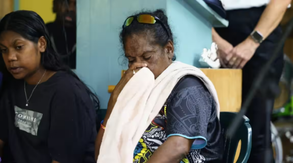 The mother of Aubrey Donahue grieves at a community meeting held at the Mareeba Community Church Fellowship in the wake of his fatal shooting. Credit: Photo: Brendan Radke