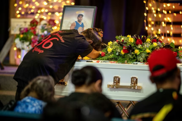 Desley Ketchup farewells her son, Aubrey Donahue, at his funeral. (ABC News: Michael Lloyd)