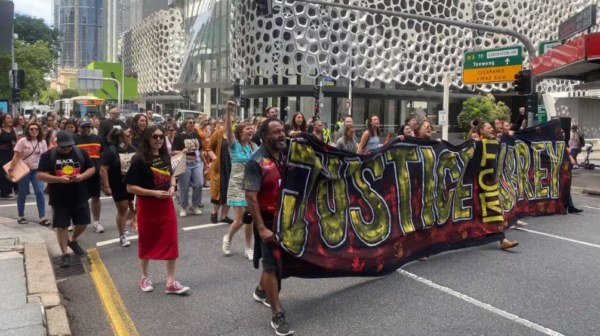 Hundreds protested through the streets of Brisbane calling for more information about the police killing of an Indigenous man in Far North Queensland. Credit: NITV/Tanisha Williams