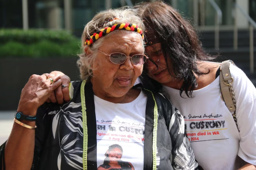Ms Dhu's grandmother, Carol Roe and her mother, Della, comfort each other outside the Perth Coroner's Court this morning.(ABC News: Laura Gartry)